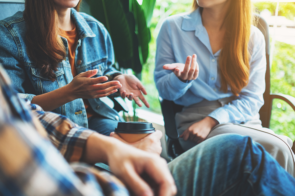 A group of young people sitting and talking together